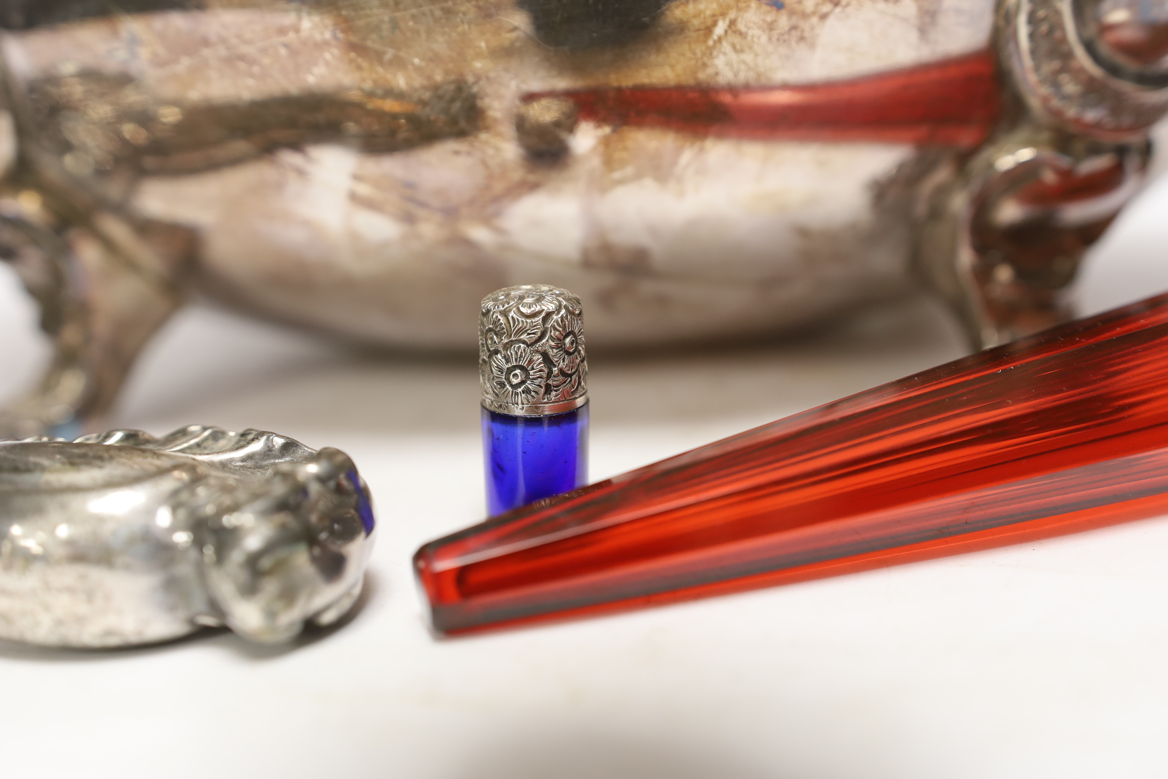 A Victorian red glass and sliver topped perfume bottle, 23cm long, a miniature blue glass silver topped bottle, together with a plated hand mirror and a tureen and cover